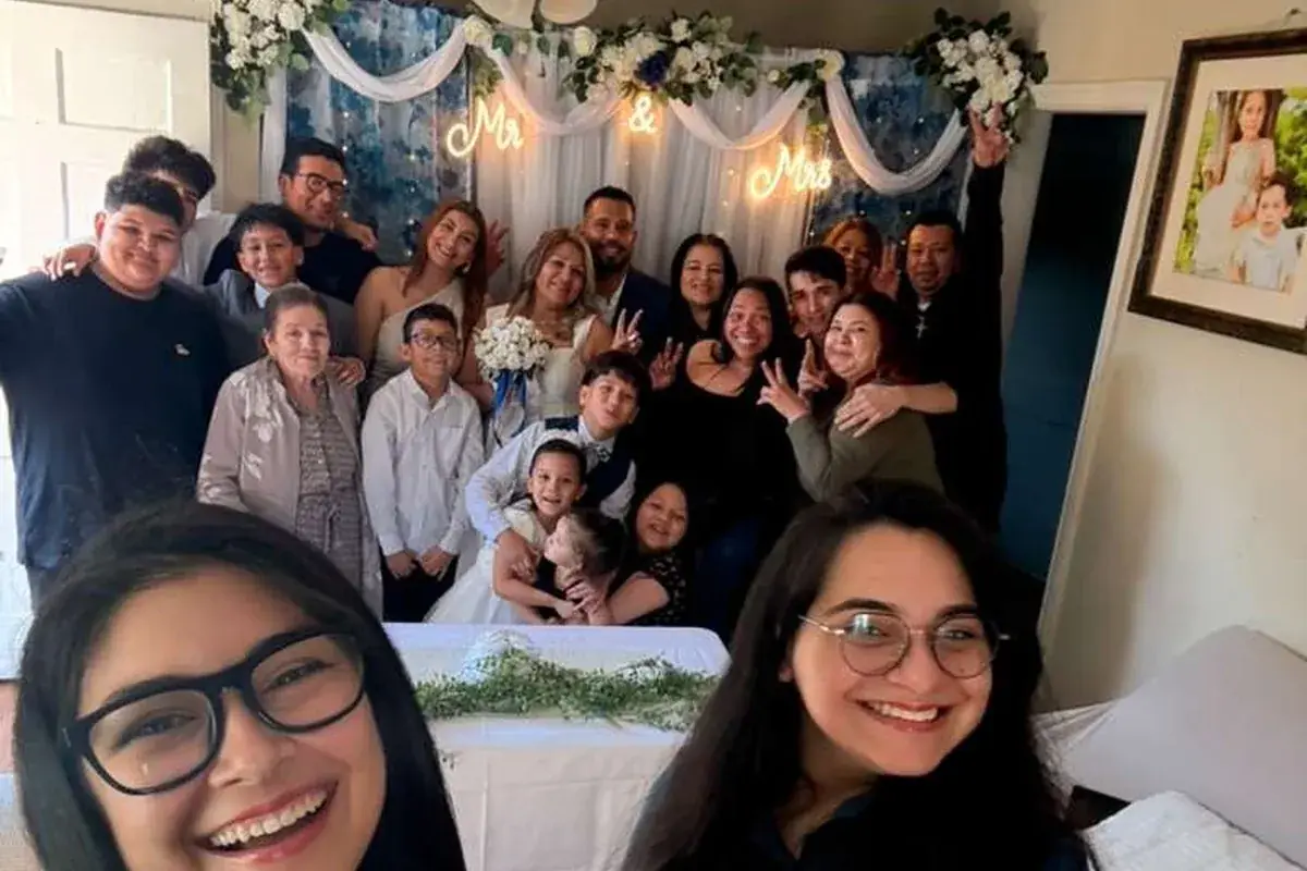 Wedding officiants celebrating with a family